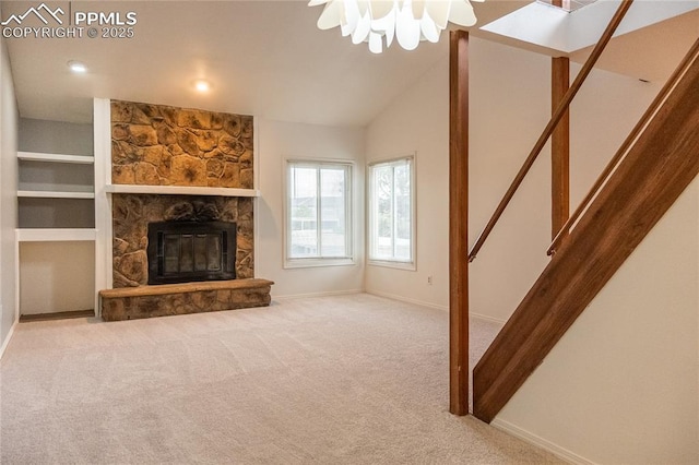 unfurnished living room featuring baseboards, carpet, and a stone fireplace