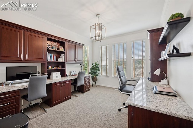office featuring a chandelier, built in desk, light carpet, baseboards, and crown molding