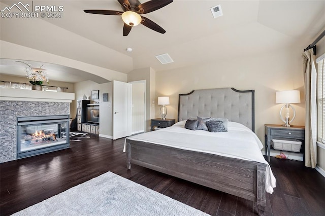 bedroom featuring visible vents, wood finished floors, and lofted ceiling