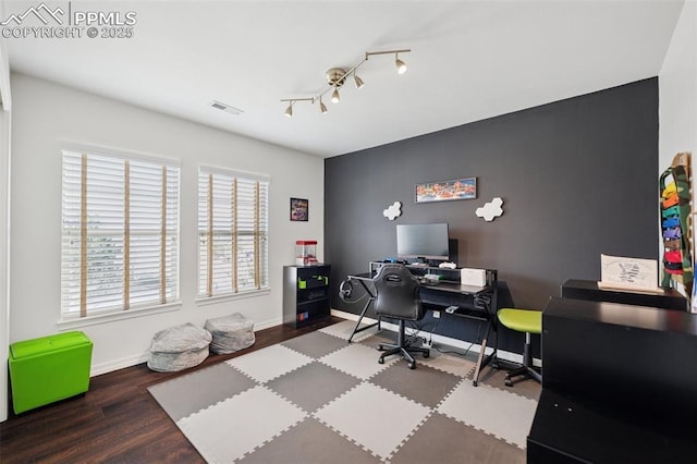 home office featuring wood finished floors, visible vents, and baseboards