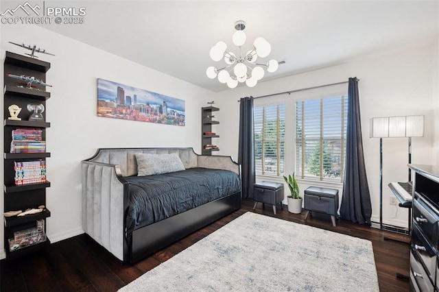 bedroom with a notable chandelier, baseboards, and dark wood-type flooring