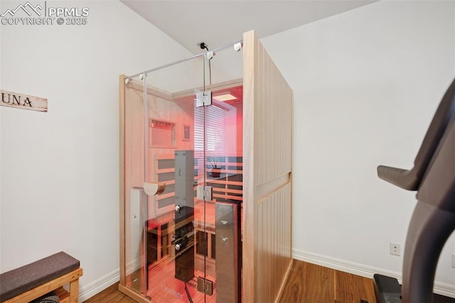interior space featuring baseboards and wood finished floors