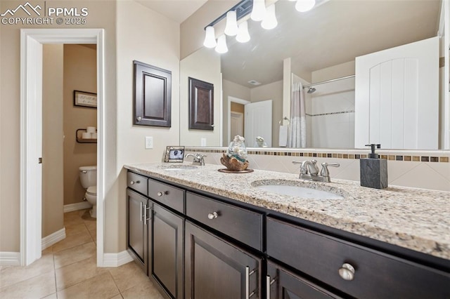 full bathroom featuring toilet, baseboards, tile patterned flooring, and a sink