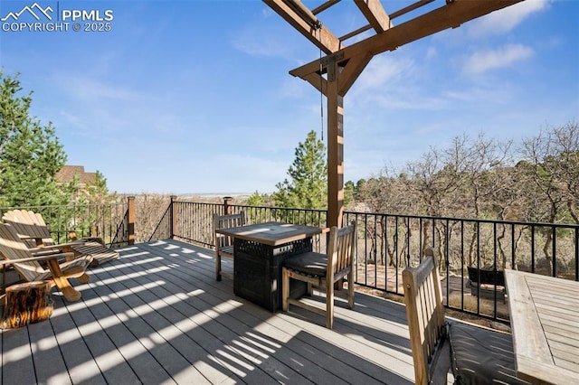 deck with a pergola and outdoor dining area