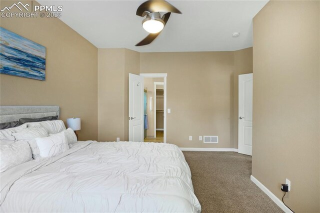 7044 Davey Crocket Ct, Colorado Springs, CO 80922 - bedroom featuring carpet floors, visible vents, baseboards, a walk in closet, and a ceiling fan