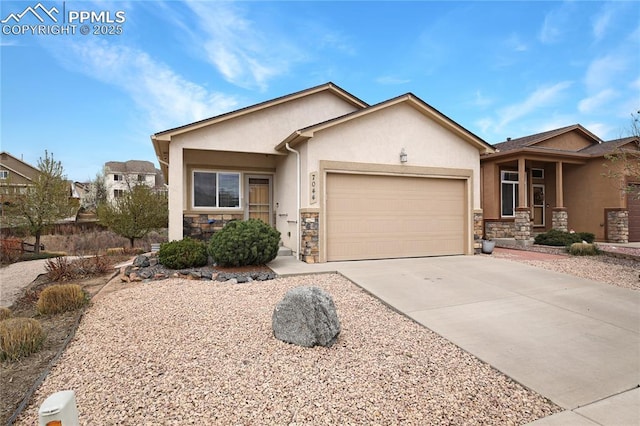view of front of house with a garage, driveway, stone siding, and stucco siding