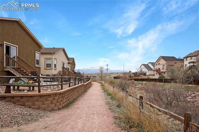 view of home's community with fence and a residential view