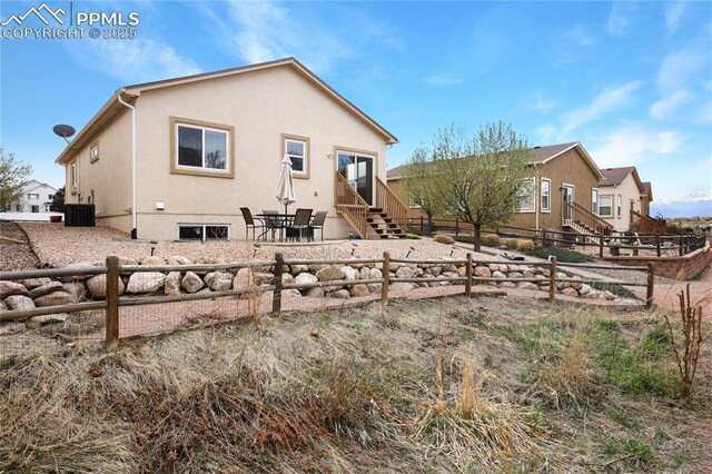 7044 Davey Crocket Ct, Colorado Springs, CO 80922 - back of property featuring cooling unit, a patio, a fenced backyard, stucco siding, and entry steps