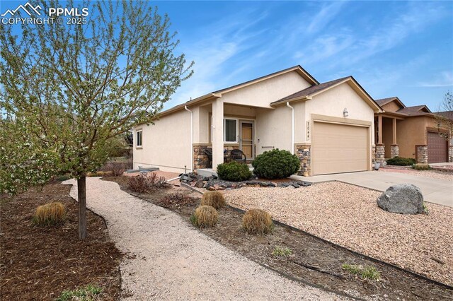 7044 Davey Crocket Ct, Colorado Springs, CO 80922 - view of front of property featuring an attached garage, stucco siding, driveway, and stone siding