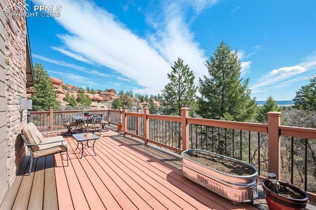 wooden terrace with outdoor dining space