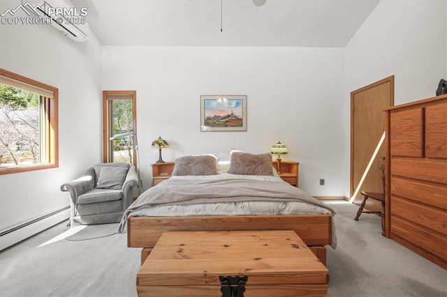 carpeted bedroom with baseboard heating and baseboards
