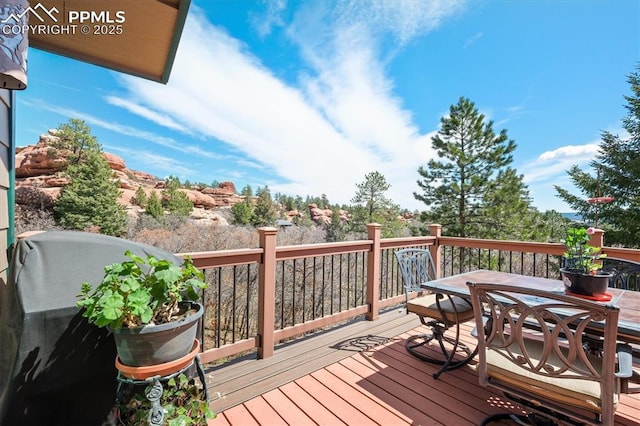 wooden terrace with outdoor dining space