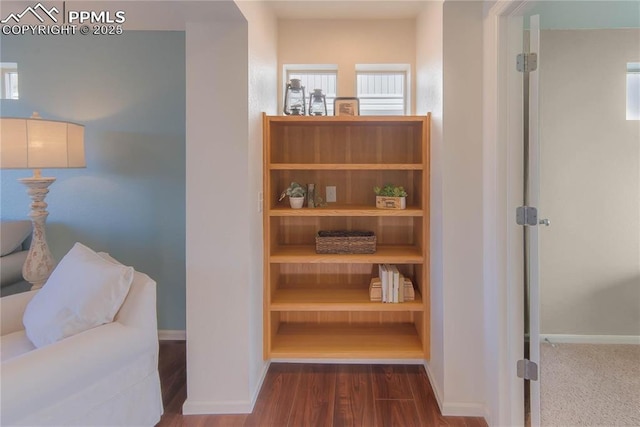 living area with baseboards and dark wood-style floors