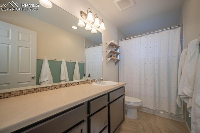 bathroom with toilet, tile patterned flooring, and vanity