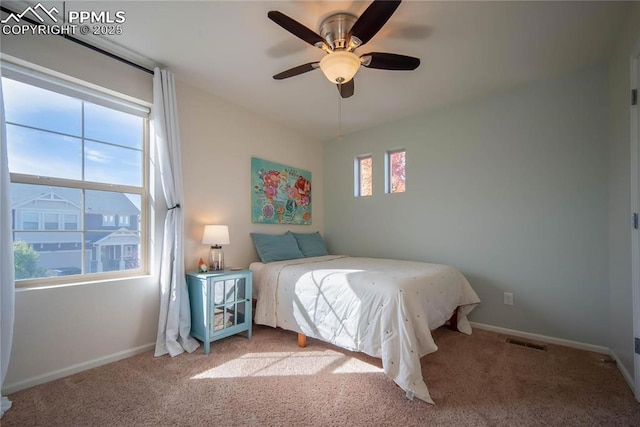 bedroom with a ceiling fan, visible vents, carpet, and baseboards