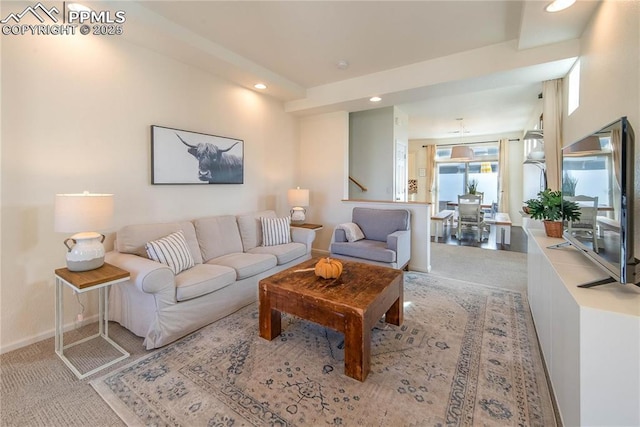 living room featuring recessed lighting, light carpet, and baseboards