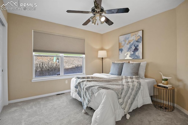 carpeted bedroom featuring visible vents, a ceiling fan, and baseboards