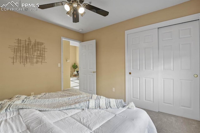 carpeted bedroom featuring a closet and a ceiling fan