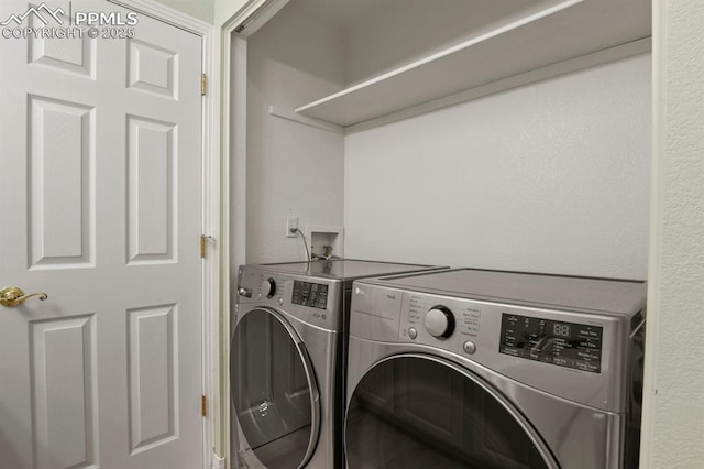 laundry room with washing machine and clothes dryer