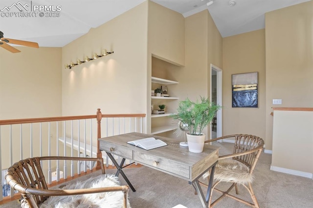 carpeted home office featuring a ceiling fan and baseboards