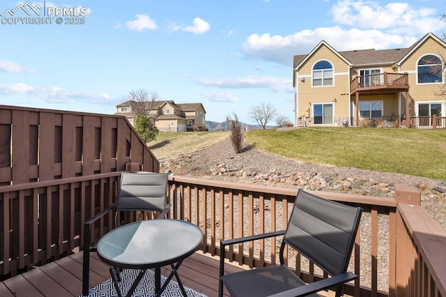 wooden terrace featuring a yard