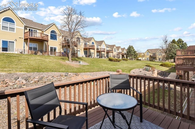 wooden terrace with a lawn and a residential view