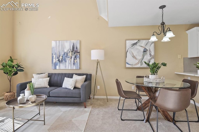 interior space with light colored carpet, baseboards, and a chandelier