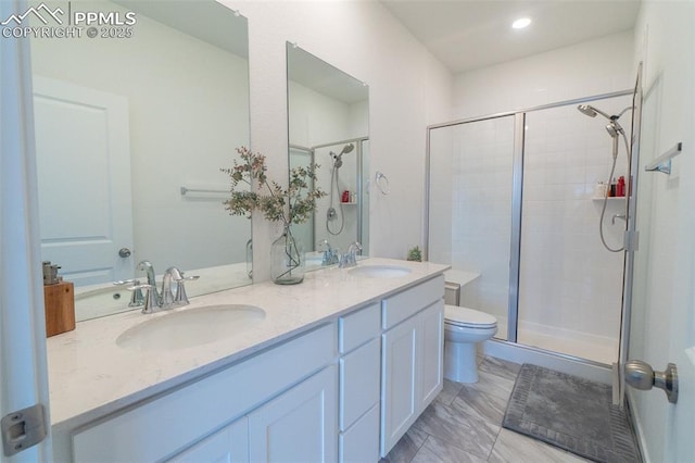 full bath with double vanity, a stall shower, and a sink