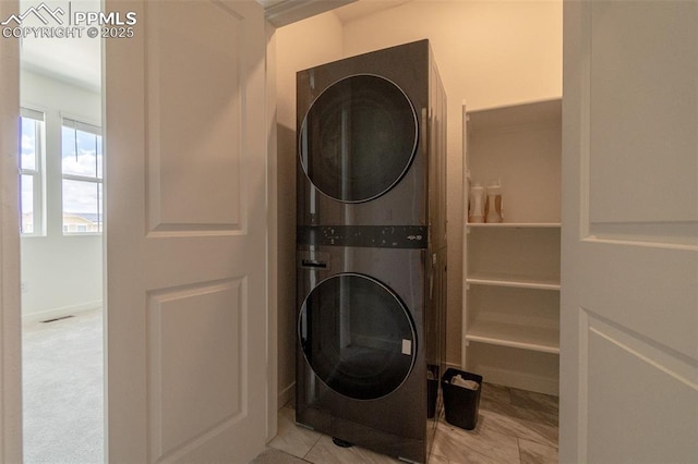laundry area with stacked washing maching and dryer and laundry area