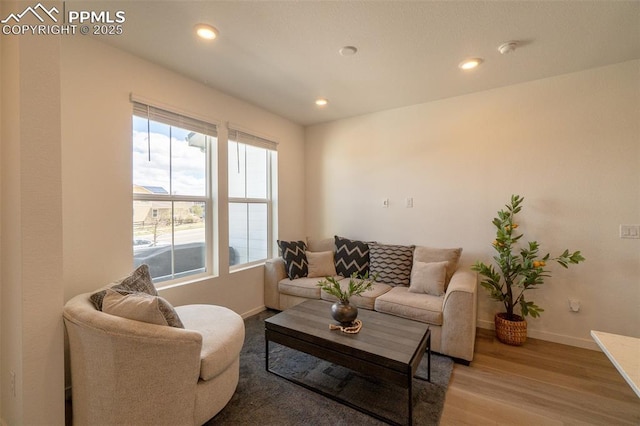 living area featuring recessed lighting, wood finished floors, and baseboards