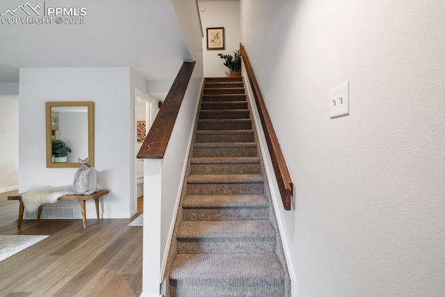 983 Moorings Dr, Colorado Springs, CO 80906 - stairs featuring baseboards, wood finished floors, and visible vents