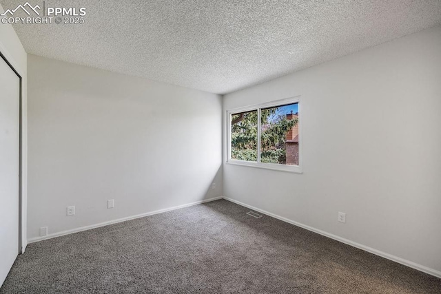 983 Moorings Dr, Colorado Springs, CO 80906 - carpeted spare room featuring baseboards, a textured ceiling, and visible vents