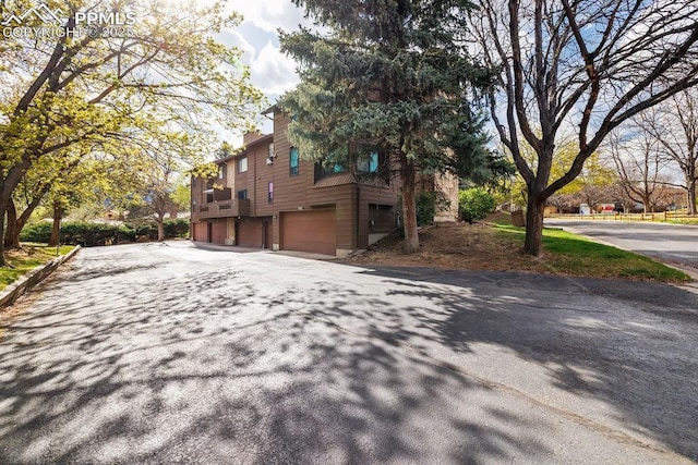983 Moorings Dr, Colorado Springs, CO 80906 - view of property exterior featuring aphalt driveway and a garage