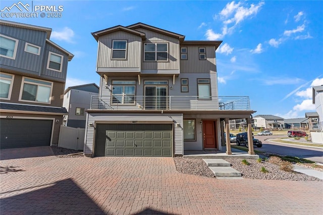 6117 Ashmore Ln, Colorado Springs, CO 80927 - view of front of property with fence, decorative driveway, a balcony, and an attached garage