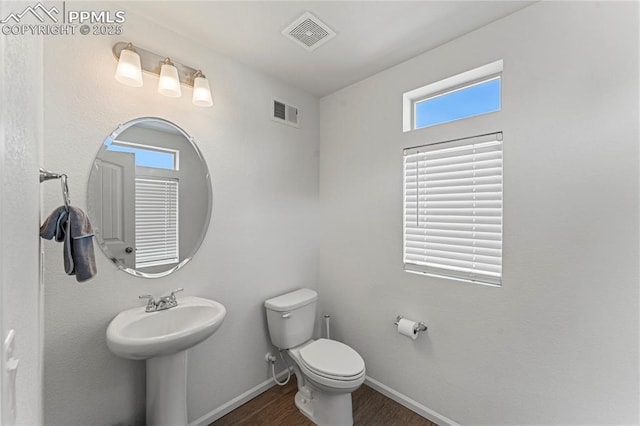 6117 Ashmore Ln, Colorado Springs, CO 80927 - bathroom featuring baseboards, visible vents, wood finished floors, and toilet