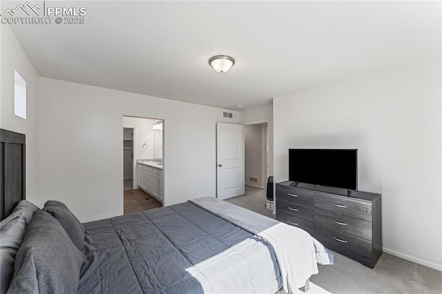 6117 Ashmore Ln, Colorado Springs, CO 80927 - bedroom with visible vents, baseboards, light colored carpet, and ensuite bath
