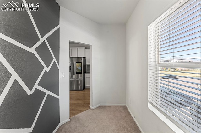 6117 Ashmore Ln, Colorado Springs, CO 80927 - hallway featuring baseboards and light carpet
