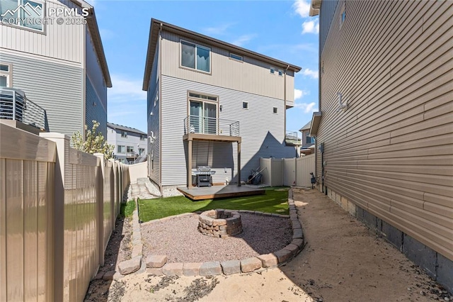 6117 Ashmore Ln, Colorado Springs, CO 80927 - back of house with an outdoor fire pit, a wooden deck, and a fenced backyard