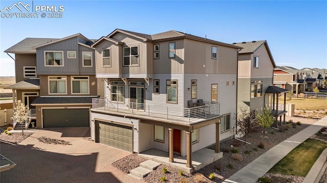 6117 Ashmore Ln, Colorado Springs, CO 80927 - view of property featuring a residential view, decorative driveway, an attached garage, and a balcony
