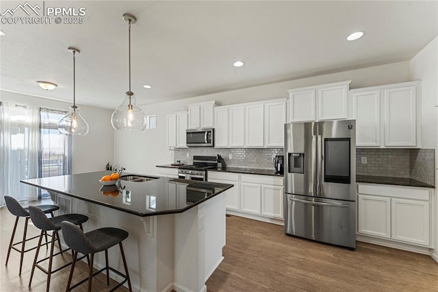 6117 Ashmore Ln, Colorado Springs, CO 80927 - kitchen featuring tasteful backsplash, dark countertops, appliances with stainless steel finishes, and a sink