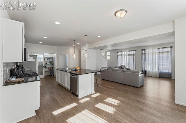 6117 Ashmore Ln, Colorado Springs, CO 80927 - kitchen with dark countertops, dark wood-style floors, and a sink