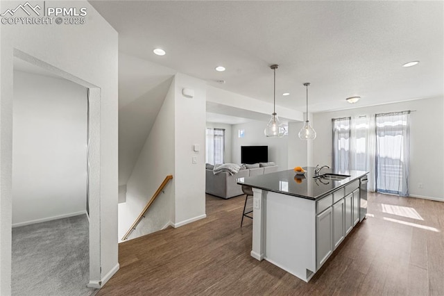6117 Ashmore Ln, Colorado Springs, CO 80927 - kitchen with open floor plan, dark countertops, a wealth of natural light, and stainless steel dishwasher