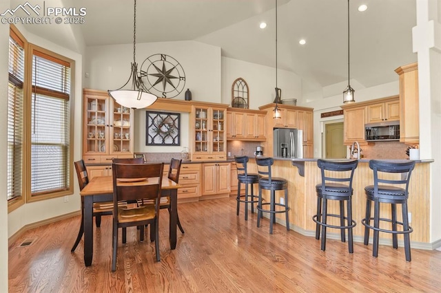 dining room with visible vents, recessed lighting, light wood-style flooring, and high vaulted ceiling