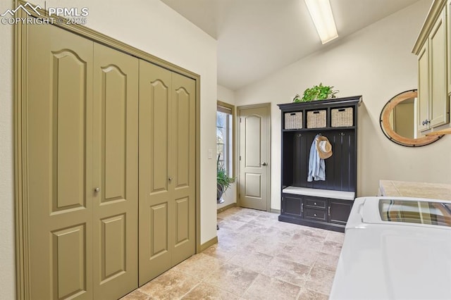mudroom with vaulted ceiling and washing machine and dryer
