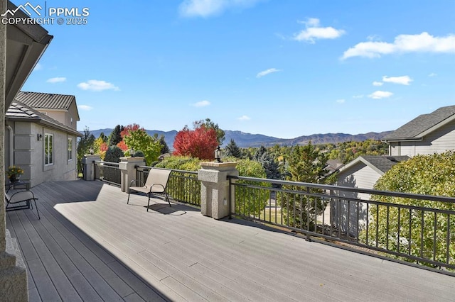 wooden deck with a mountain view