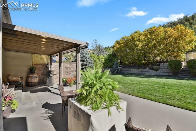 view of patio featuring area for grilling and fence