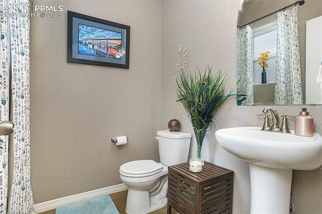 12857 Morning Breeze Way, Peyton, CO 80831 - bathroom featuring baseboards, a textured wall, and toilet
