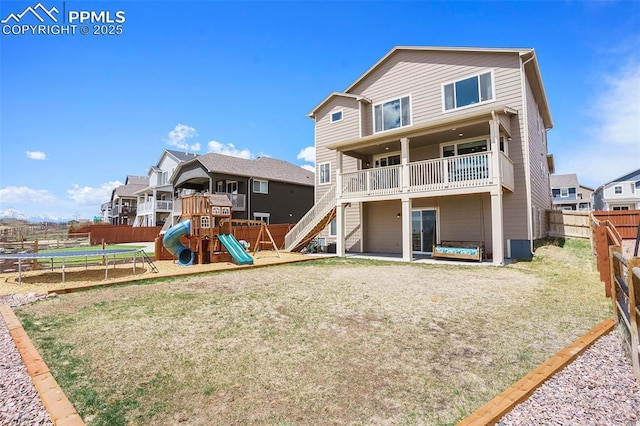 12857 Morning Breeze Way, Peyton, CO 80831 - back of house with a fenced backyard, a playground, a lawn, a trampoline, and a residential view
