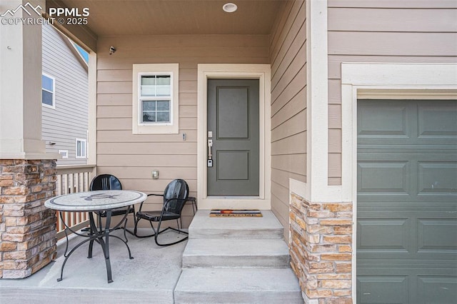 12857 Morning Breeze Way, Peyton, CO 80831 - doorway to property featuring stone siding and a garage