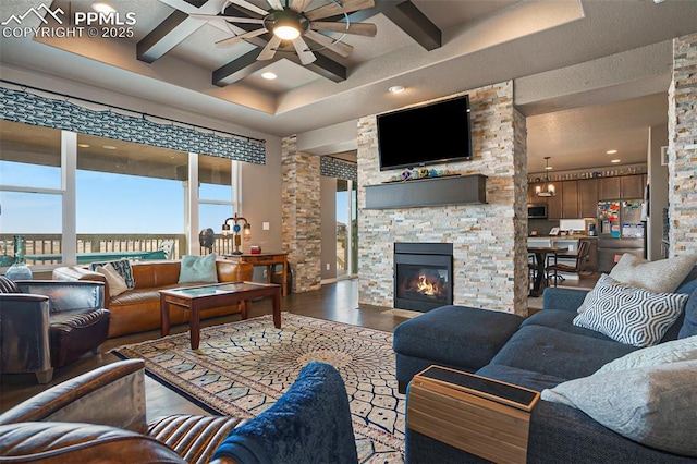 12857 Morning Breeze Way, Peyton, CO 80831 - living area with a ceiling fan, wood finished floors, ornate columns, coffered ceiling, and recessed lighting